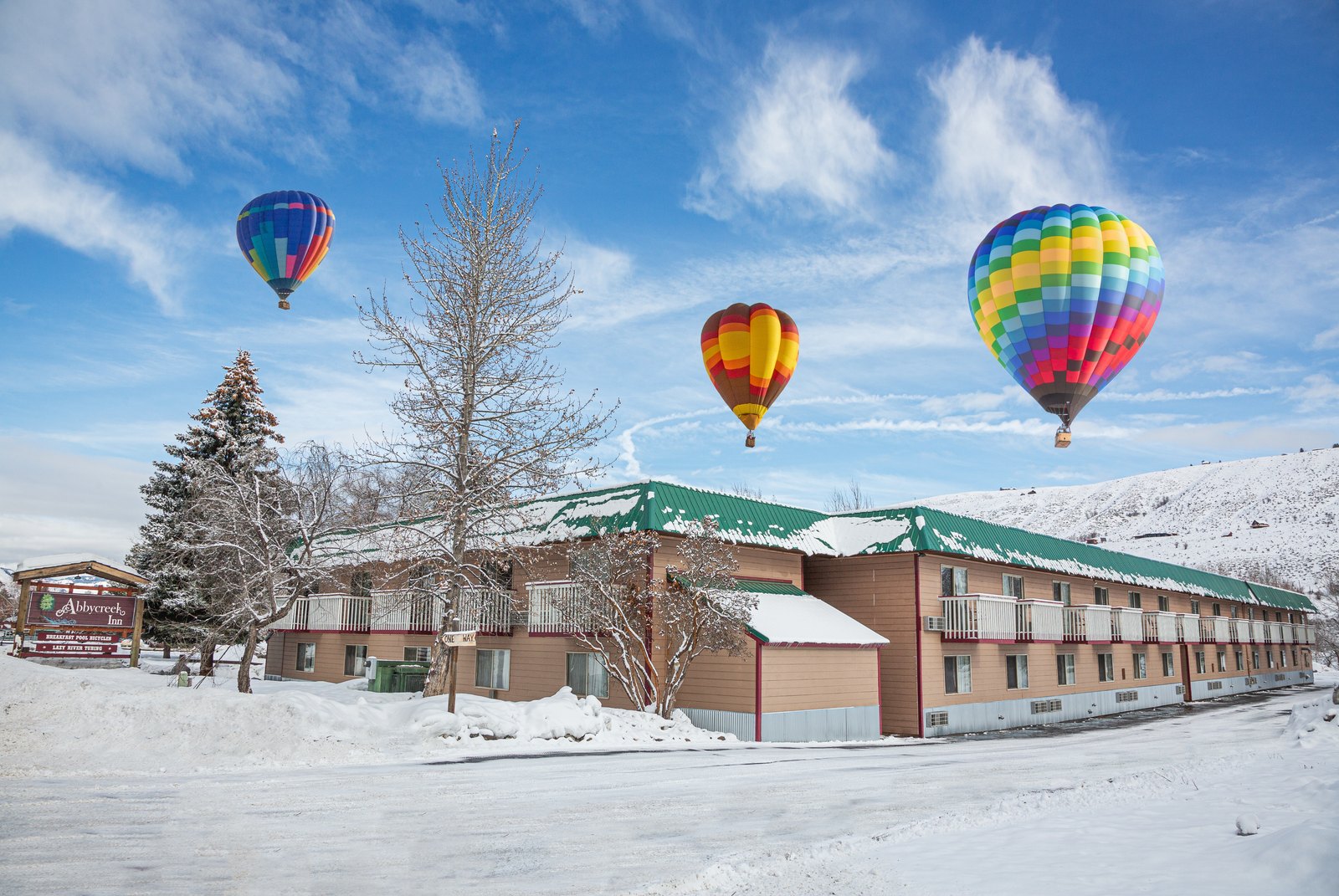 Hot-air balloons rising over snowy Abbycreek Inn