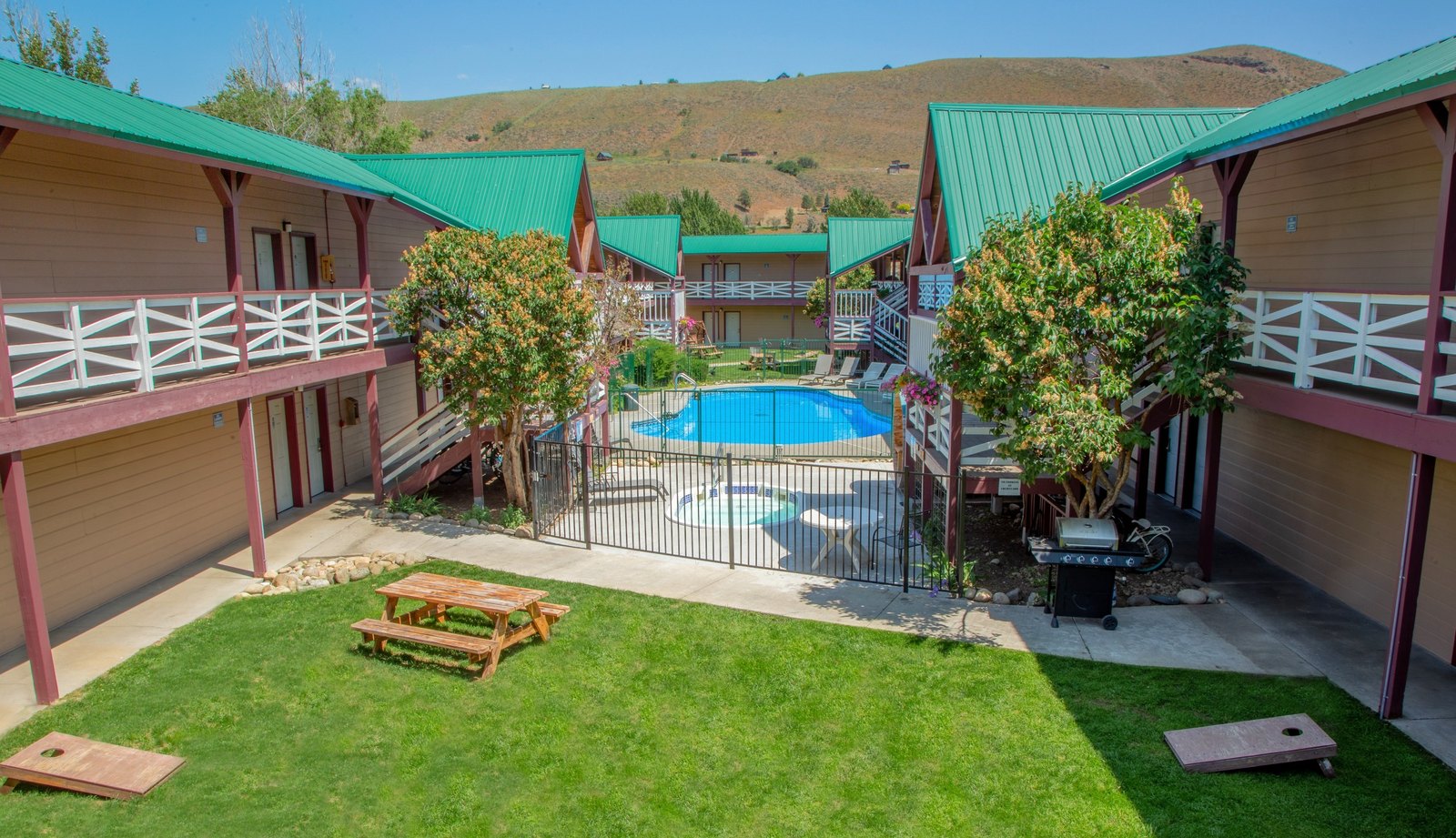 Abbycreek Inn courtyard with pool, lawn and picnic tables