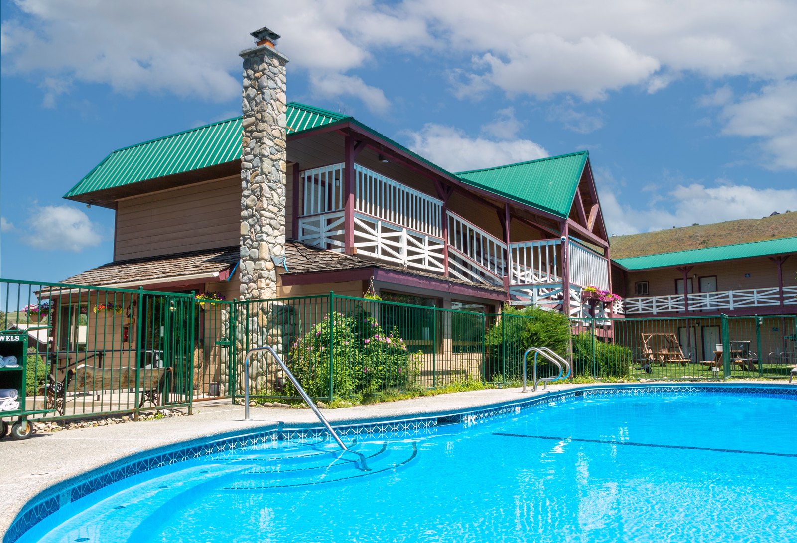 Heated outdoor pool surrounded by the two-story inn